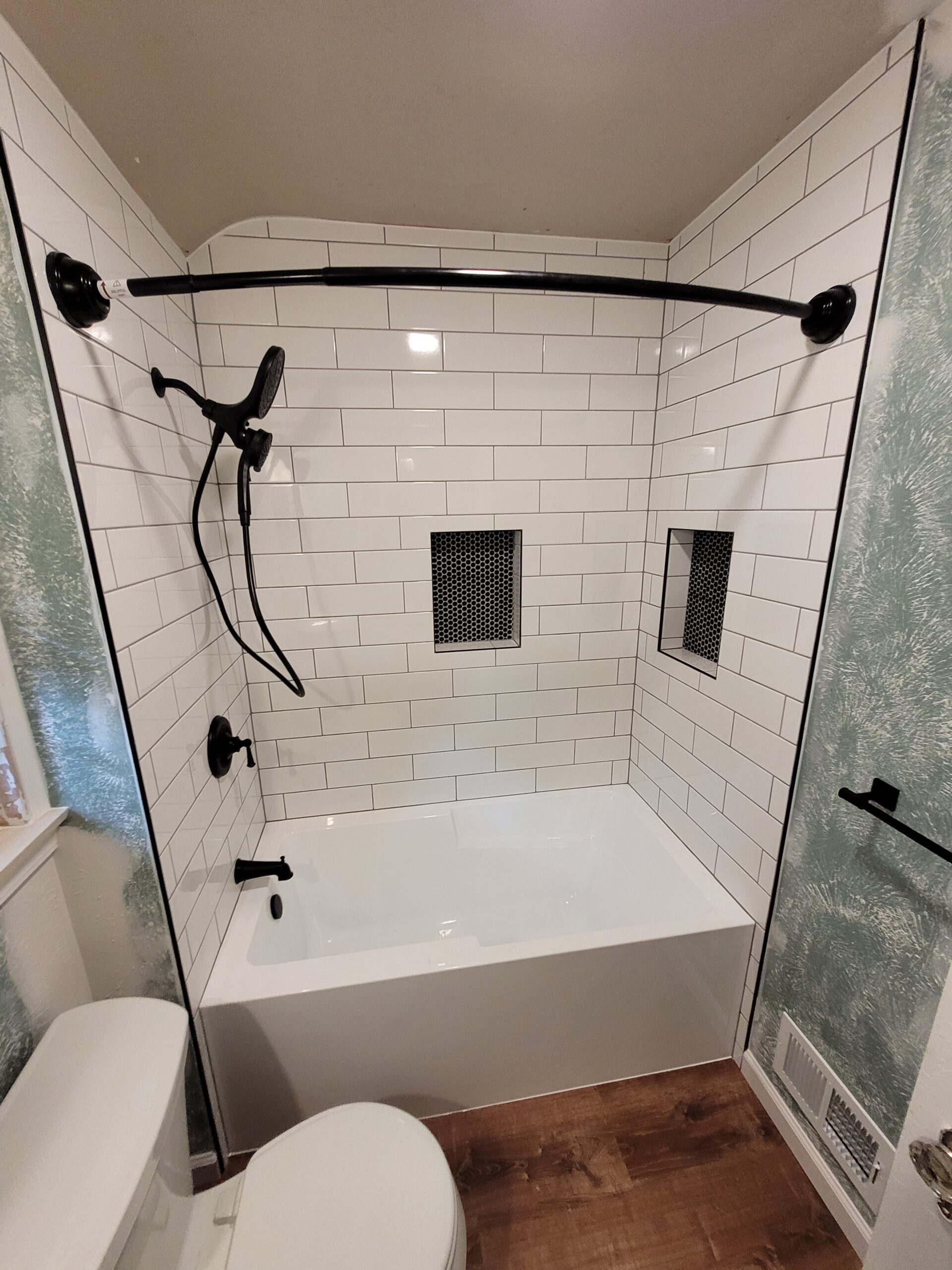 Read more about the article Subway tile shower with black fixtures