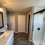 subway tile shower with a bench