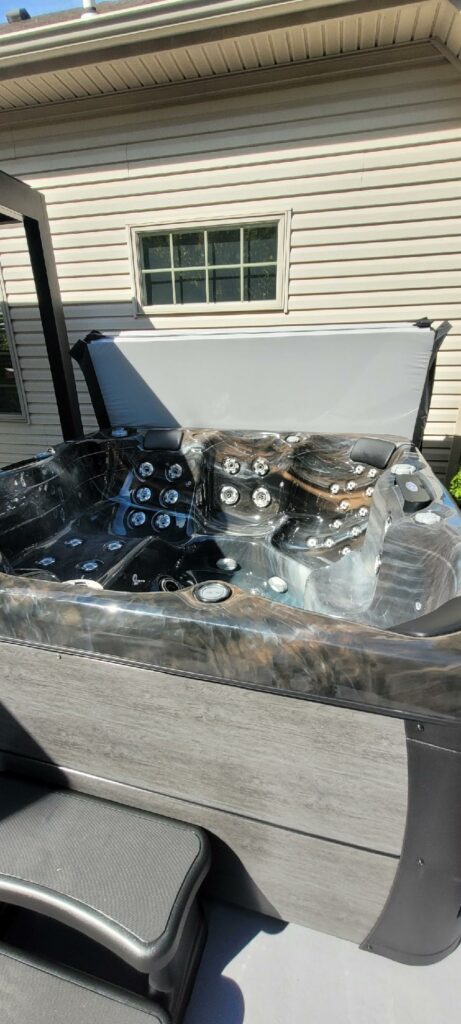 Concrete Patio with a Pergola and Hot Tub